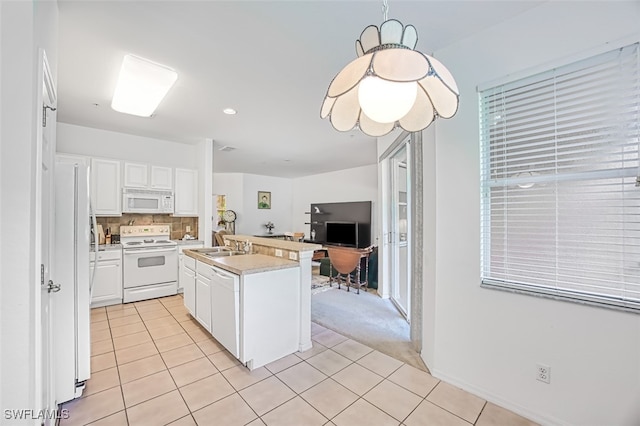 kitchen featuring a kitchen island with sink, white appliances, tasteful backsplash, and white cabinetry