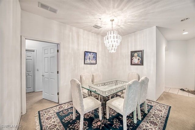 carpeted dining space with an inviting chandelier