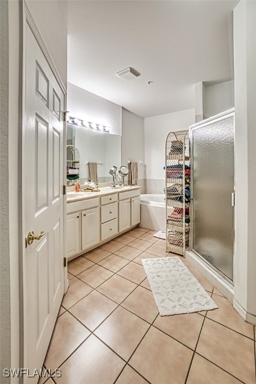 bathroom featuring vanity, tile patterned floors, and plus walk in shower