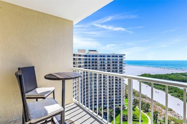 balcony with a water view and a beach view