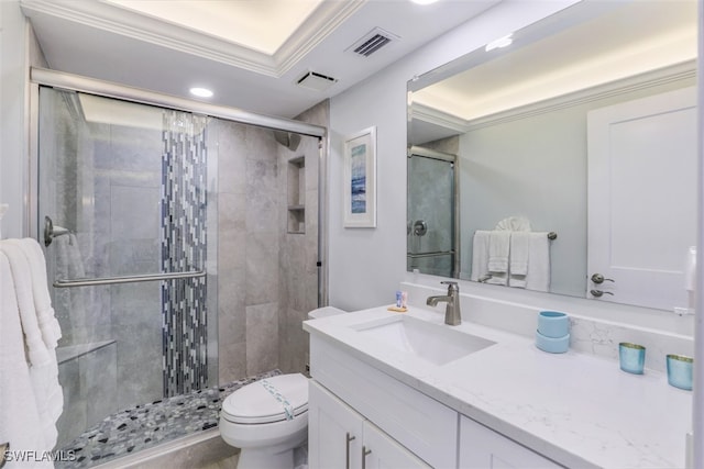 bathroom with vanity, a shower with door, and toilet