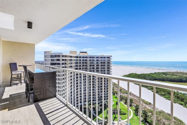 balcony featuring a water view and a view of the beach