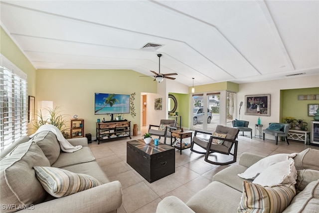 tiled living room with lofted ceiling, ceiling fan, and french doors