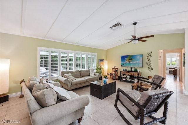 living room featuring light tile patterned flooring, vaulted ceiling, and ceiling fan