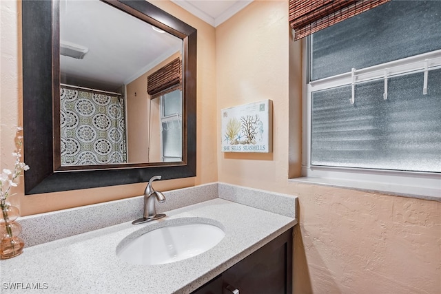 bathroom featuring crown molding and vanity