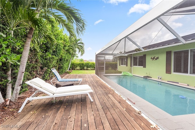 view of pool with a deck and glass enclosure