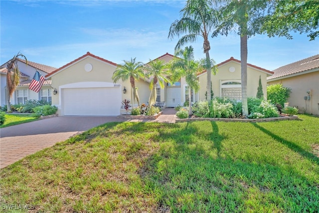 mediterranean / spanish home with a front yard and a garage