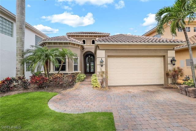 mediterranean / spanish-style house featuring a garage