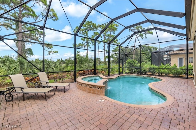 view of swimming pool featuring glass enclosure, a patio, and an in ground hot tub