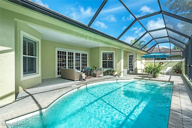 view of pool featuring a patio area and glass enclosure