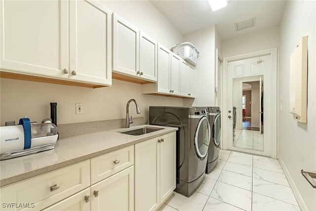 laundry area with visible vents, cabinet space, a sink, washing machine and dryer, and marble finish floor