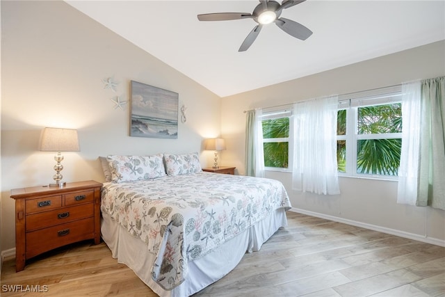 bedroom with ceiling fan, light wood-type flooring, and lofted ceiling