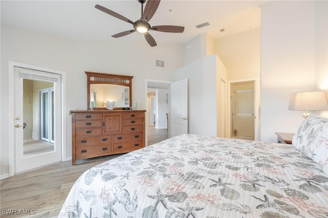 bedroom with light hardwood / wood-style flooring, lofted ceiling, a closet, and ceiling fan