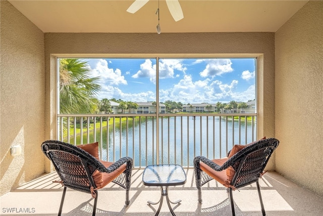 sunroom / solarium with a water view, ceiling fan, and plenty of natural light