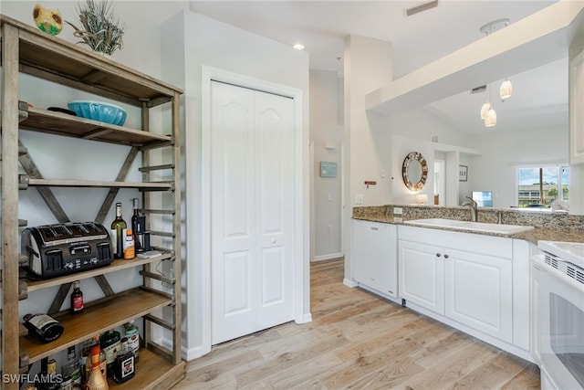 kitchen featuring white cabinets, dishwasher, light wood-type flooring, sink, and range