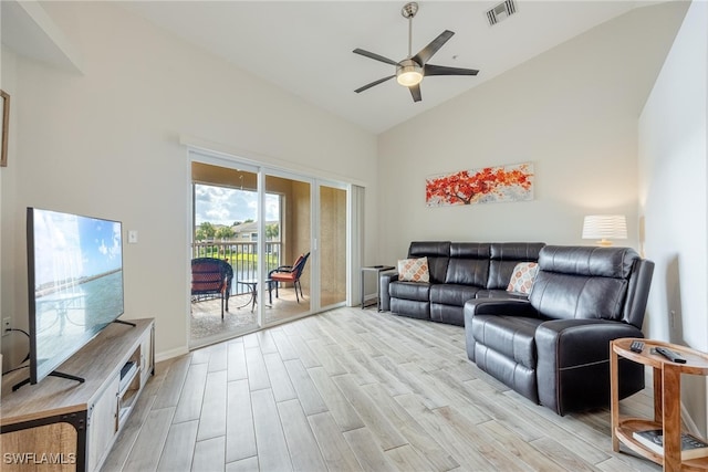 living room with ceiling fan, high vaulted ceiling, and light hardwood / wood-style flooring