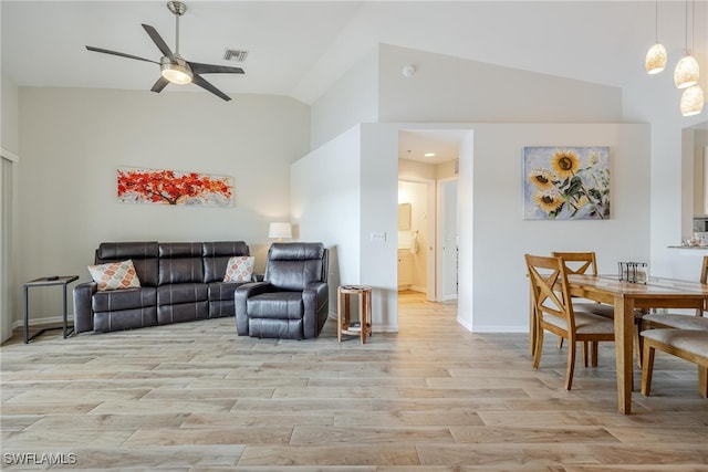 living room with ceiling fan, light wood-type flooring, and vaulted ceiling