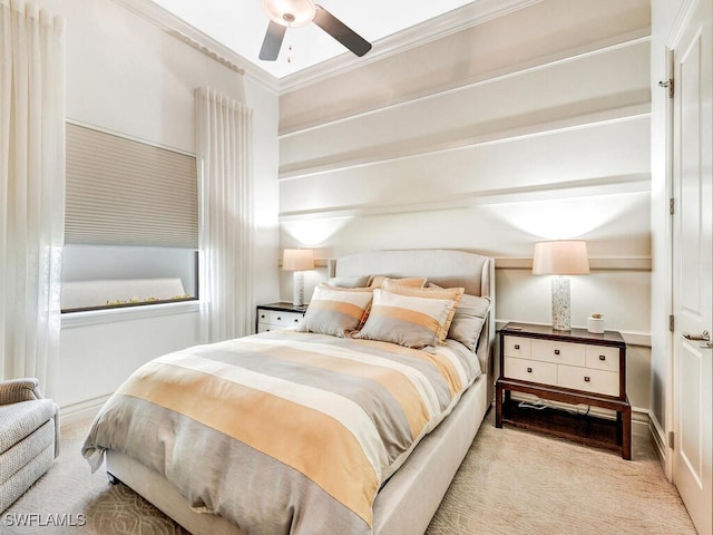 bedroom featuring ceiling fan, ornamental molding, and carpet