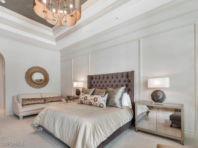 bedroom featuring arched walkways, a raised ceiling, ornamental molding, an inviting chandelier, and carpet