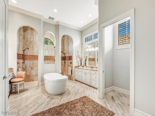 bathroom featuring a walk in shower, visible vents, vanity, a freestanding bath, and crown molding