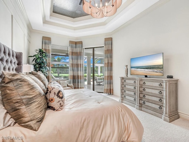 bedroom with a tray ceiling, ornamental molding, carpet flooring, and access to exterior