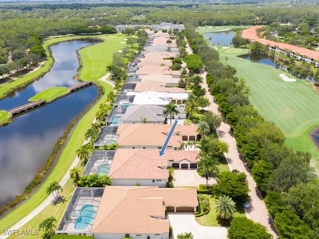 aerial view with golf course view, a water view, and a residential view