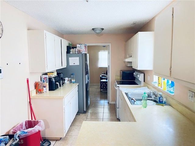 kitchen featuring electric stove, a textured ceiling, white cabinets, sink, and light tile patterned flooring