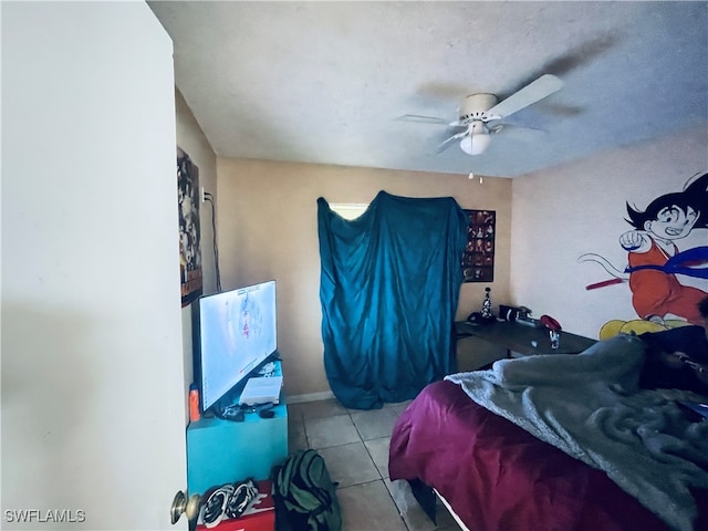 tiled bedroom featuring ceiling fan