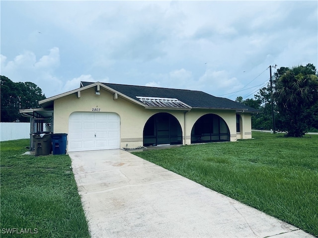 view of front of home featuring a garage and a front yard