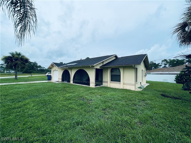 ranch-style house featuring a front yard and a garage