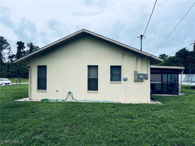 view of side of property with a yard