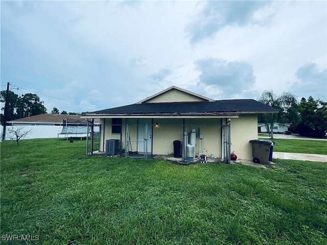 2807 E 8th St, Lehigh Acres, FL 33972 - back of property featuring cooling unit, an exterior structure, an outdoor structure, and stucco siding