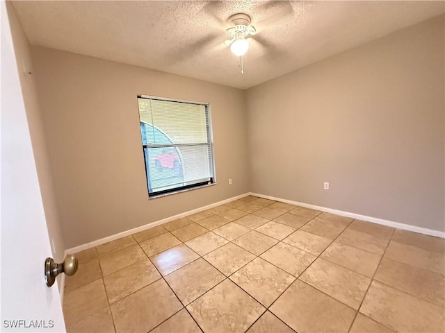 2807 E 8th St, Lehigh Acres, FL 33972 - unfurnished room featuring a textured ceiling, light tile patterned floors, a ceiling fan, and baseboards