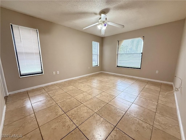 2807 E 8th St, Lehigh Acres, FL 33972 - empty room featuring light tile patterned floors, ceiling fan, a textured ceiling, and baseboards