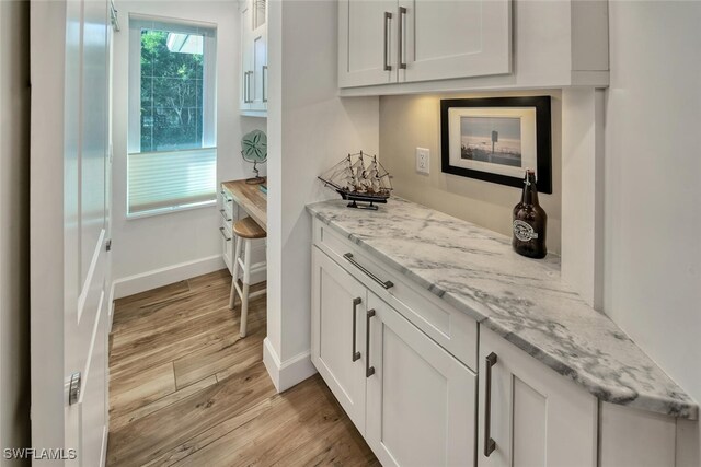 bar with light wood-type flooring and baseboards