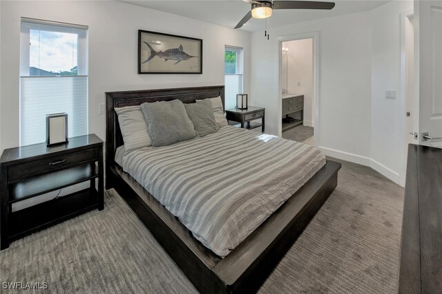 bedroom with a ceiling fan, connected bathroom, baseboards, and carpet flooring