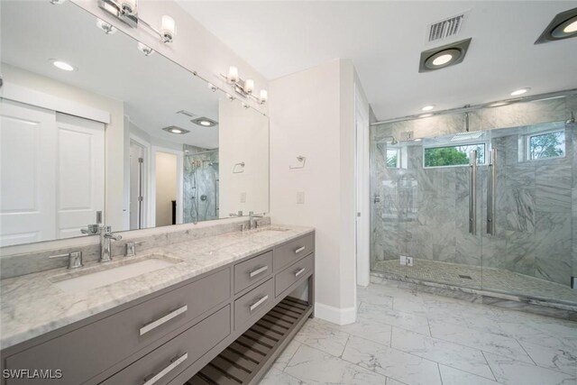 bathroom featuring double vanity, a marble finish shower, visible vents, marble finish floor, and a sink