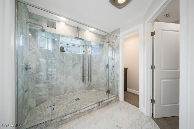 bathroom featuring marble finish floor, visible vents, baseboards, and a marble finish shower