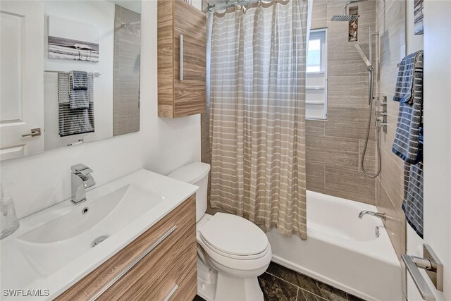 bathroom featuring shower / tub combo, vanity, and toilet