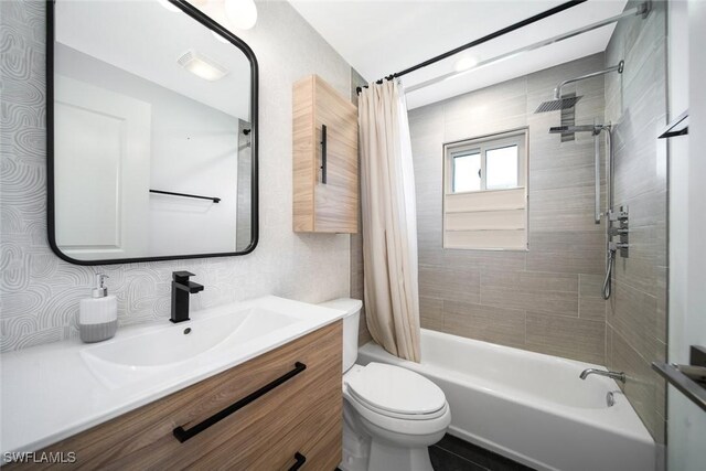 bathroom with toilet, shower / tub combo with curtain, and vanity