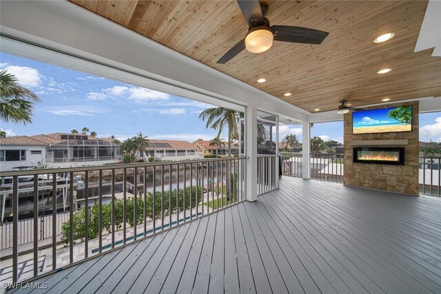 wooden deck featuring ceiling fan