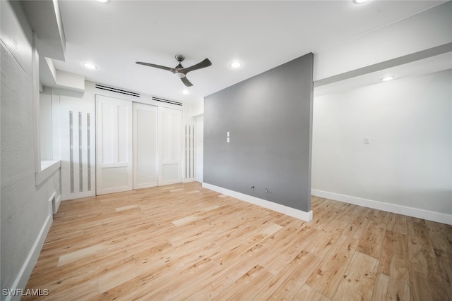 spare room featuring ceiling fan and light hardwood / wood-style floors