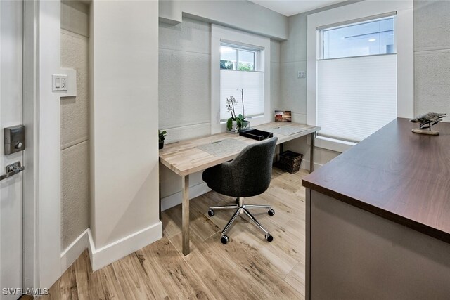 office featuring baseboards and light wood-style floors