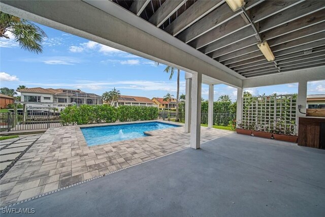 view of swimming pool with a patio area, fence, and a fenced in pool