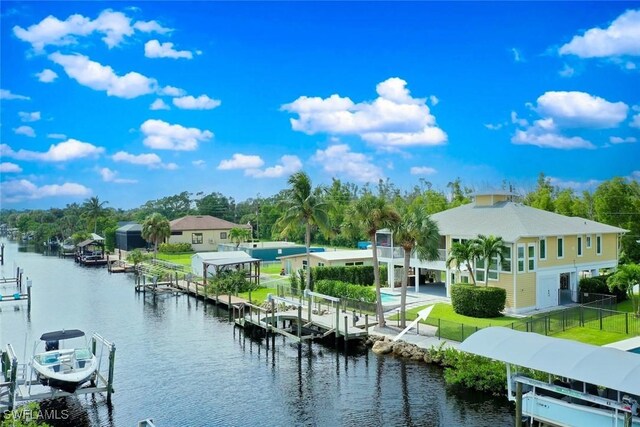 exterior space featuring a dock, boat lift, and fence