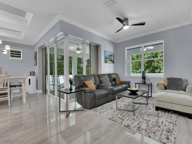 living room featuring ornamental molding, visible vents, baseboards, and a ceiling fan