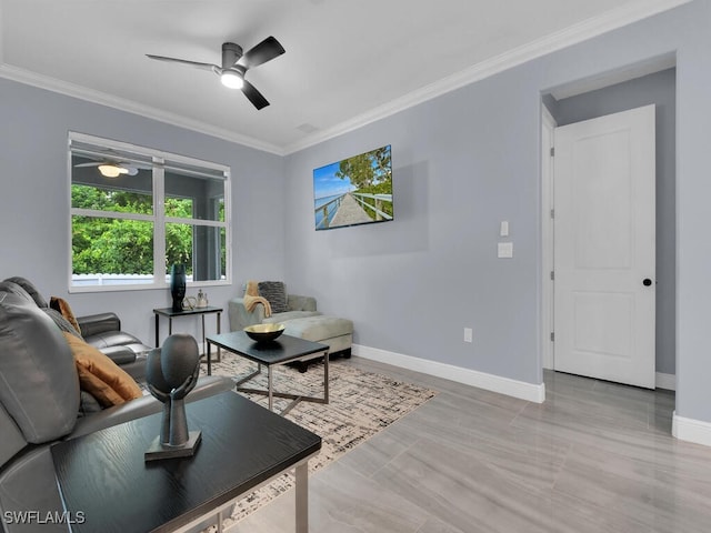 living room featuring ceiling fan, ornamental molding, and baseboards