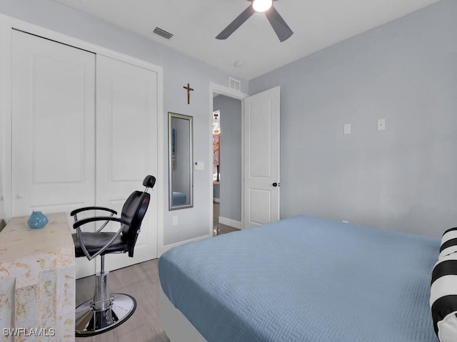 bedroom featuring a closet, visible vents, and a ceiling fan