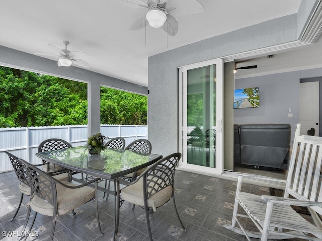 view of patio / terrace with ceiling fan, outdoor dining area, and fence