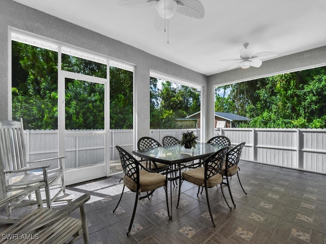 sunroom / solarium featuring ceiling fan